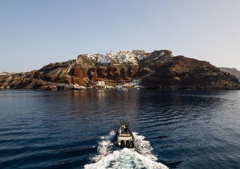 A tour boat crossing the caldera towards the volcano islet