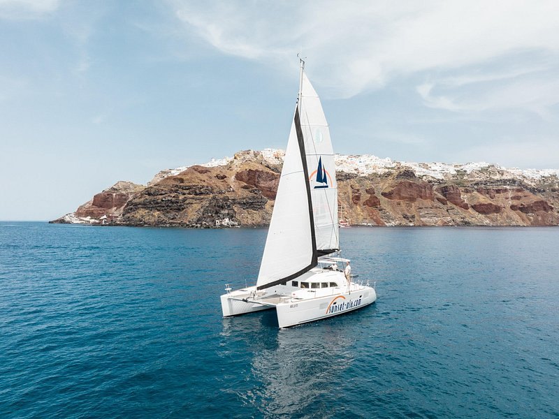 A catamaran crossing the caldera in front of Nea Kameni