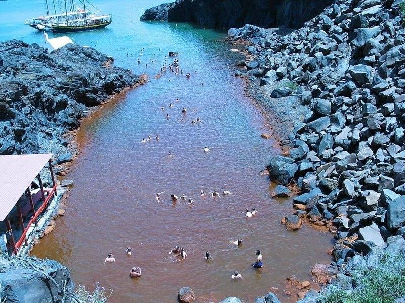 The rust-red water of the Palea Kameni hot springs, stained by iron